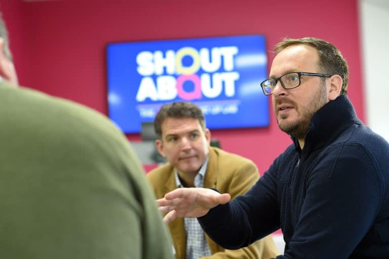 High-quality business meeting in Suffolk with professionals discussing marketing strategies.