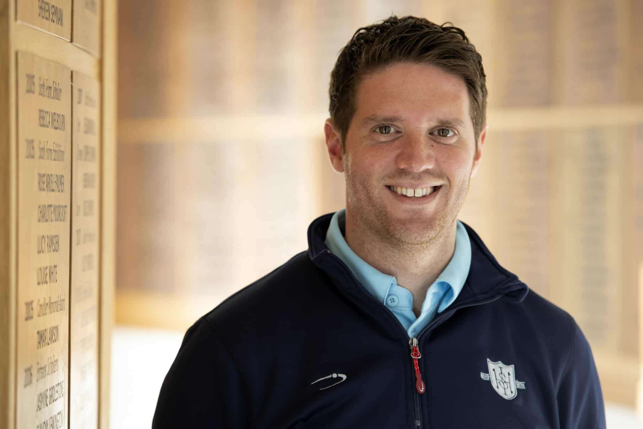 Professional portrait of a Suffolk businessperson smiling indoors.