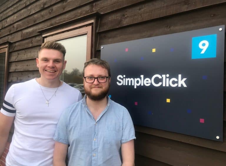 Two men standing outside SimpleClick office in Suffolk, smiling for the camera.