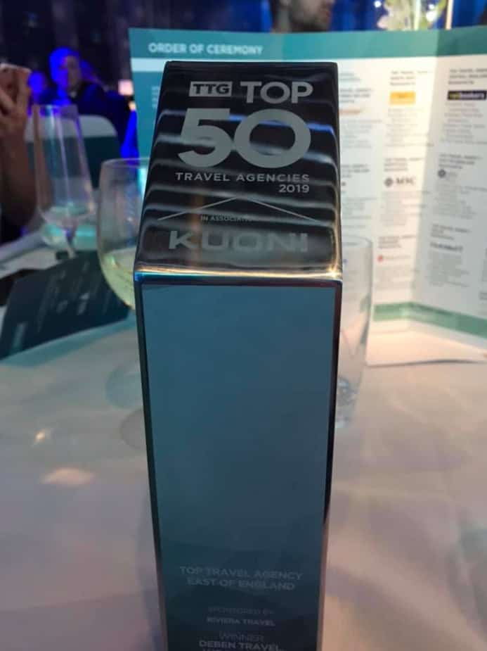 Award-winning TTG Top 50 Travel Agency trophy at a formal event in Suffolk, highlighting excellence.