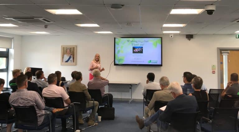 Workshop on business growth strategies with a presenter in a Suffolk conference room.