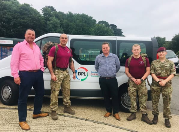 Suffolk Business team standing beside DPL vehicle with military personnel and staff.