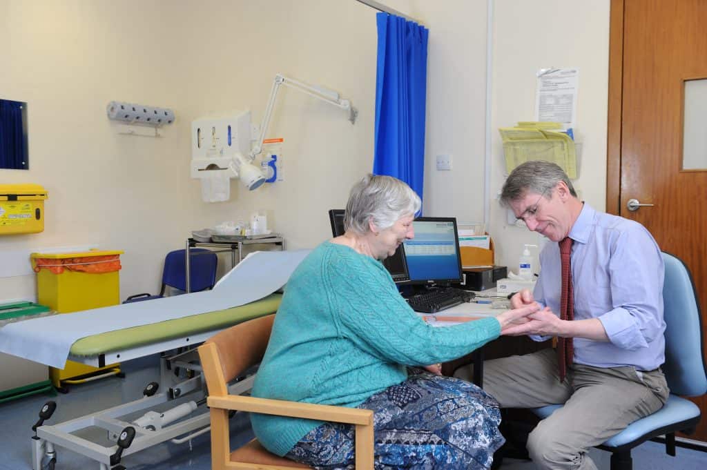 Patient consultation with healthcare professional in a medical clinic.