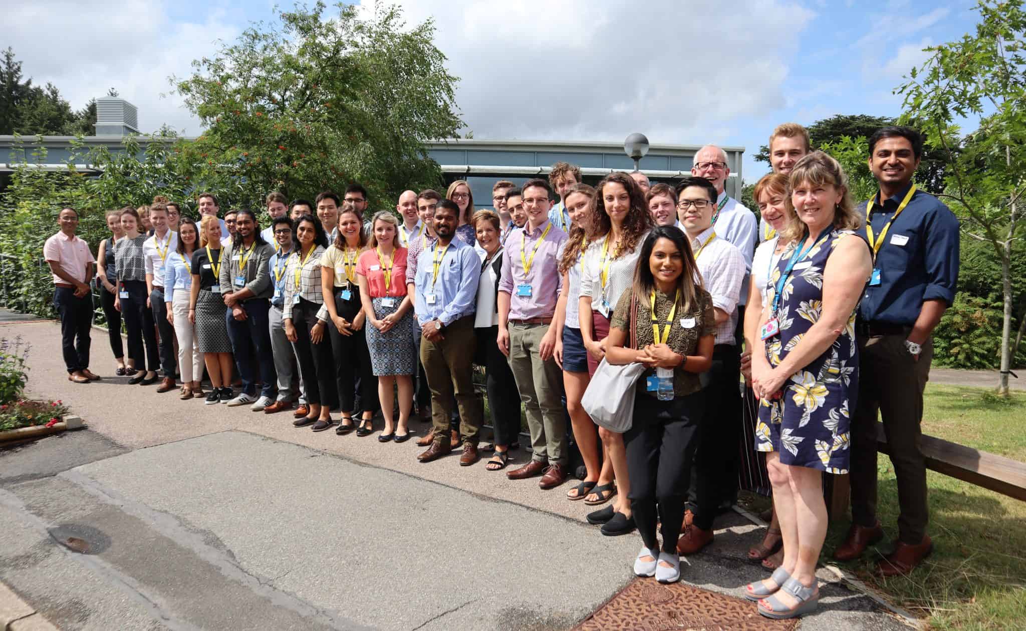 Team of diverse professionals at Suffolk Business networking event outdoors.