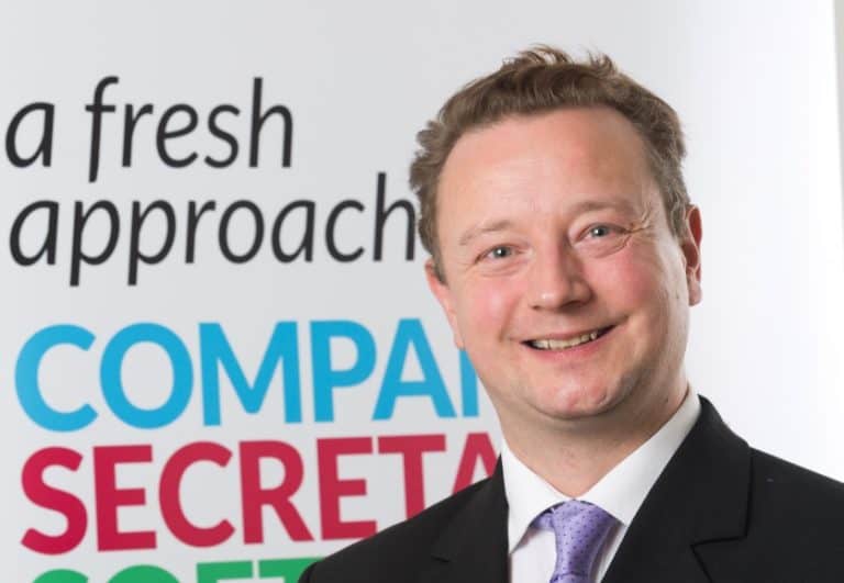 Business professional smiling, promoting Suffolk Business services and consultancy expertise.