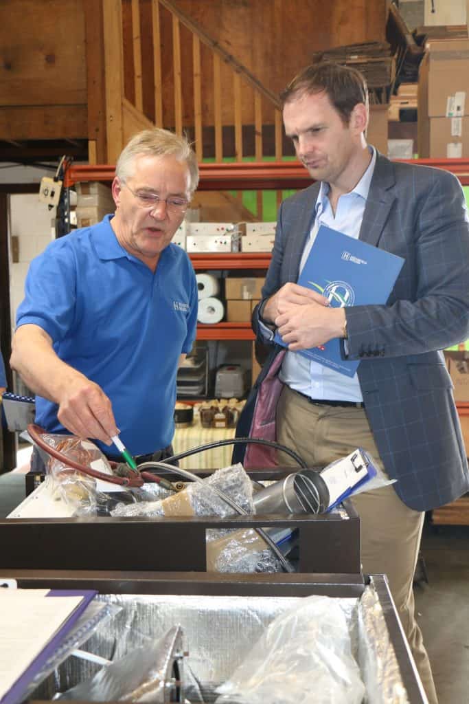 Businessmen discussing products in a warehouse setting in Suffolk.
