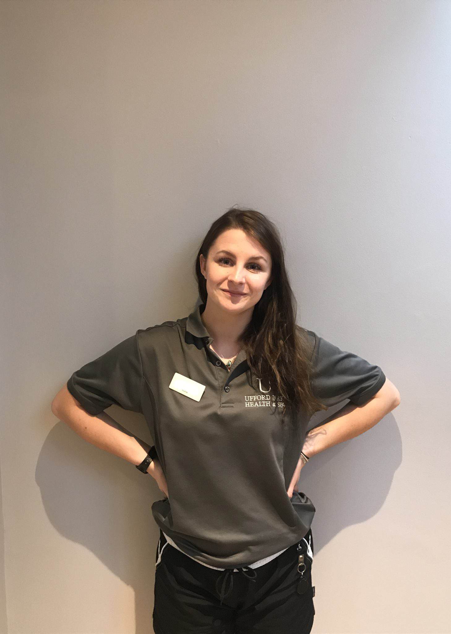 Staff member in Suffolk Business uniform smiling confidently.
