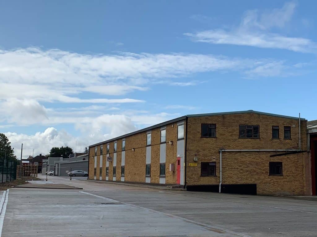 Industrial warehouse in Suffolk with brick and metal exterior.