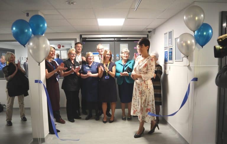 Business office opening event with staff and ribbon-cutting in Suffolk.