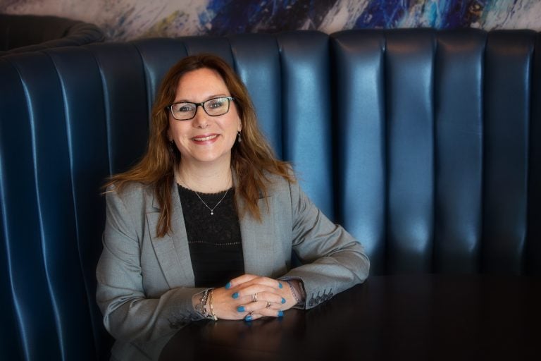 Businesswoman smiling at a meeting in Suffolk, showcasing professional success.