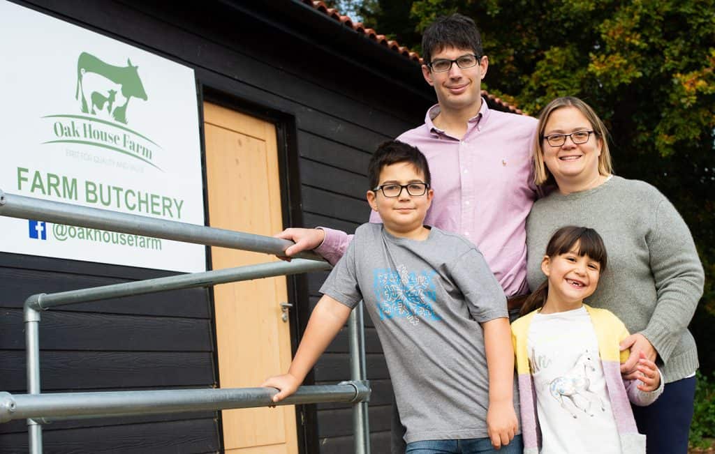 Family enjoying a visit to Oak House Farm butchery in Suffolk, showcasing local farm products and fa.