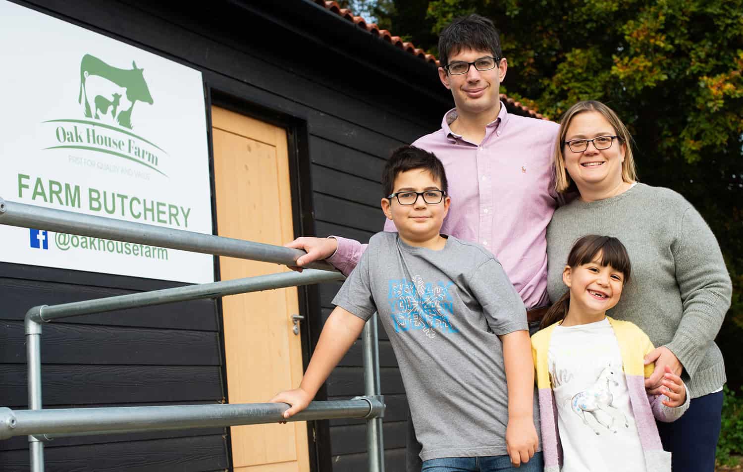 Family enjoying a visit to Oak House Farm butchery in Suffolk, showcasing local farm products and fa.