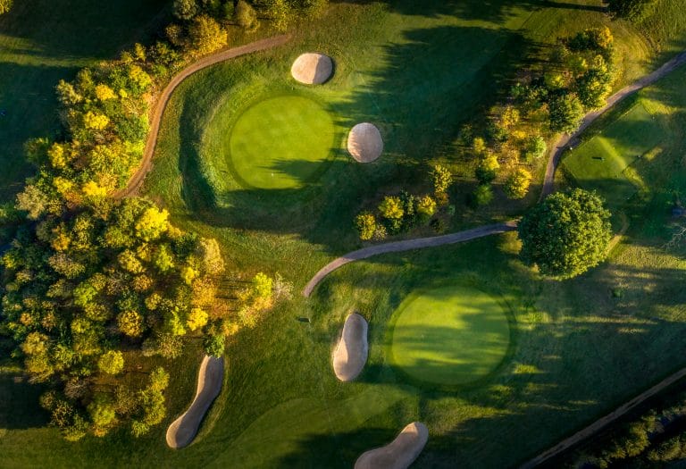 Golf course with sand traps and lush greenery in Suffolk, UK.