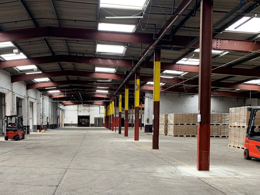 Suffolk warehouse with pallets and forklifts for logistics and storage solutions.