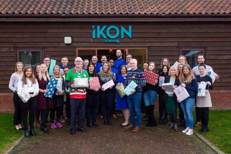 Group of employees celebrating Christmas at Suffolk Business training centre with gifts.