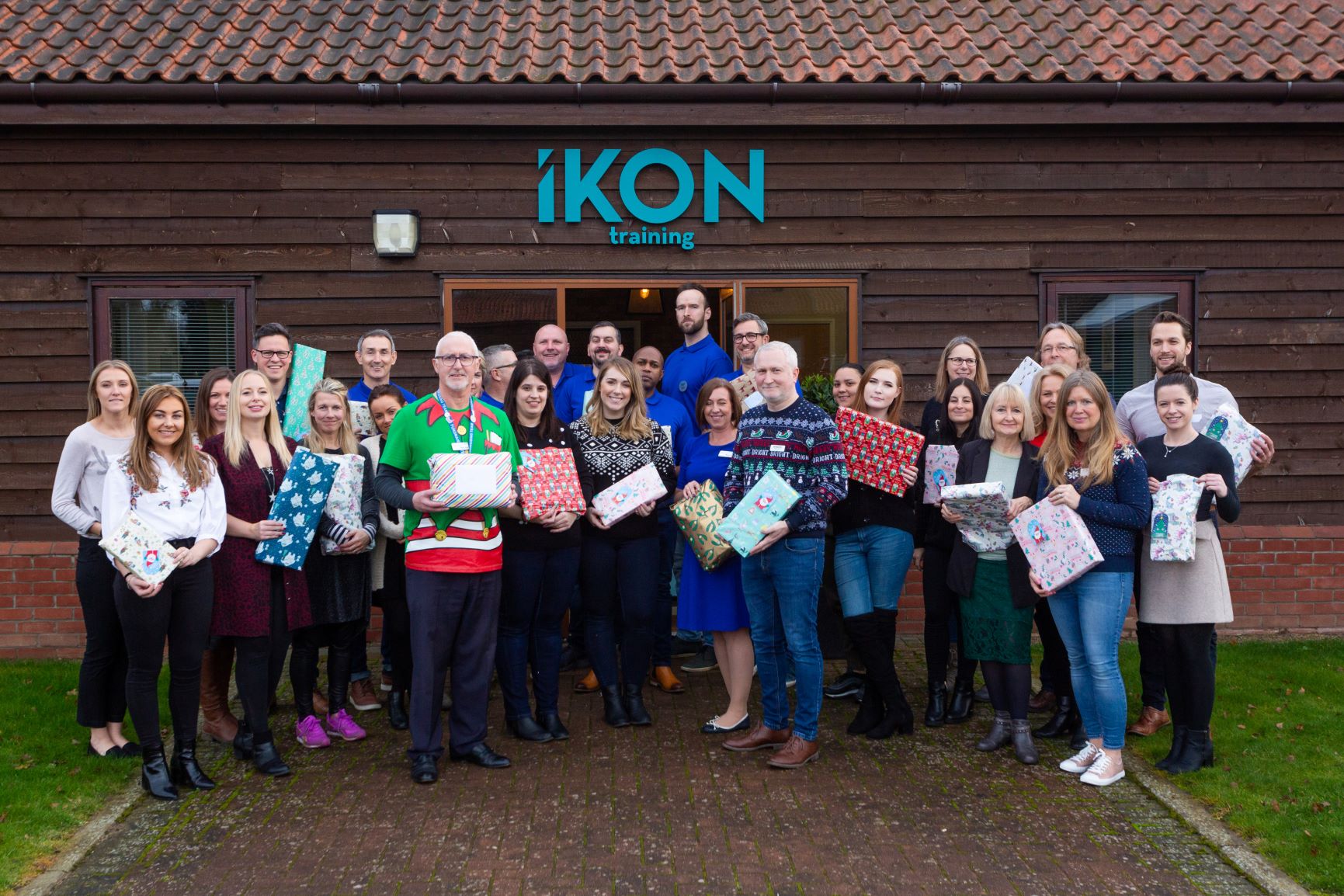 Group of employees celebrating Christmas at Suffolk Business training centre with gifts.