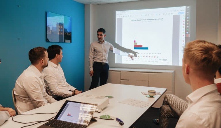 Business meeting presentation with data analysis in a modern office.