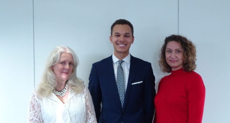 Business professionals standing together in Suffolk office for a corporate meeting.