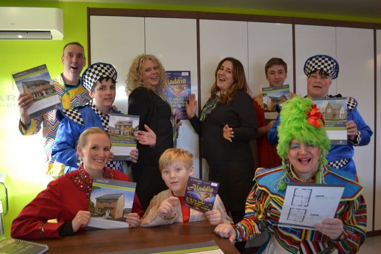 Suffolk Business team with children and clown entertainer in colourful costumes.