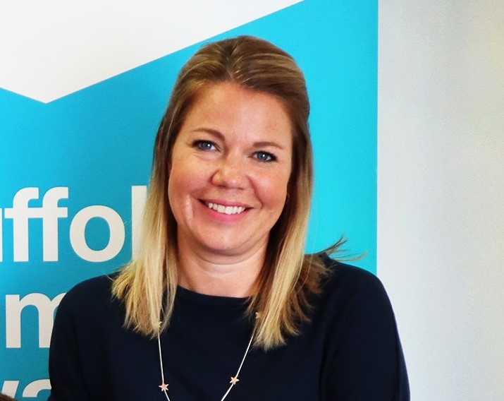 A woman smiling at a Suffolk Business event or office.