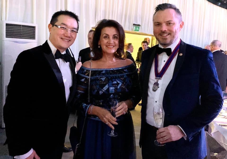 Business professionals at Suffolk Business Awards gala event in formal attire.