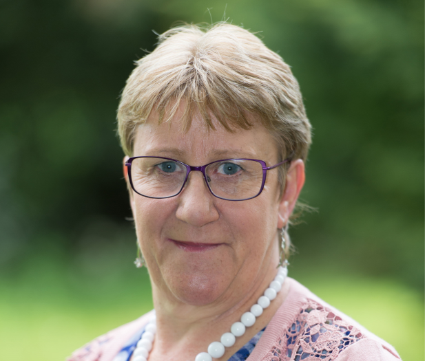Portrait of a professional woman in Suffolk, showcasing business leadership and community engagement.