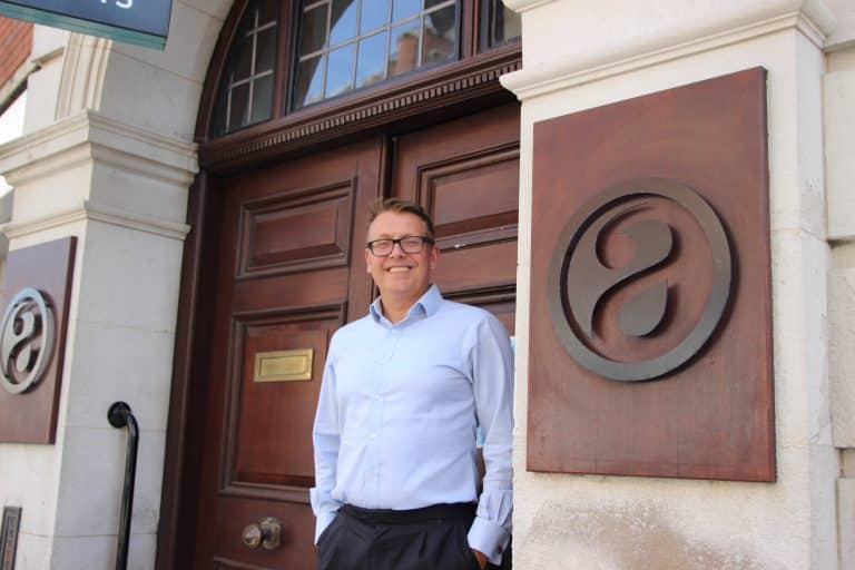 Business professional standing outside Suffolk Business office in Suffolk, UK.