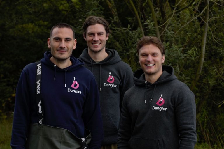 Group of three smiling men in Suffolk, wearing Dangler hoodies outdoors.