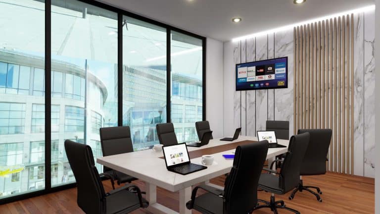 Conference room with large windows, digital display screens, and ergonomic chairs for professional m.