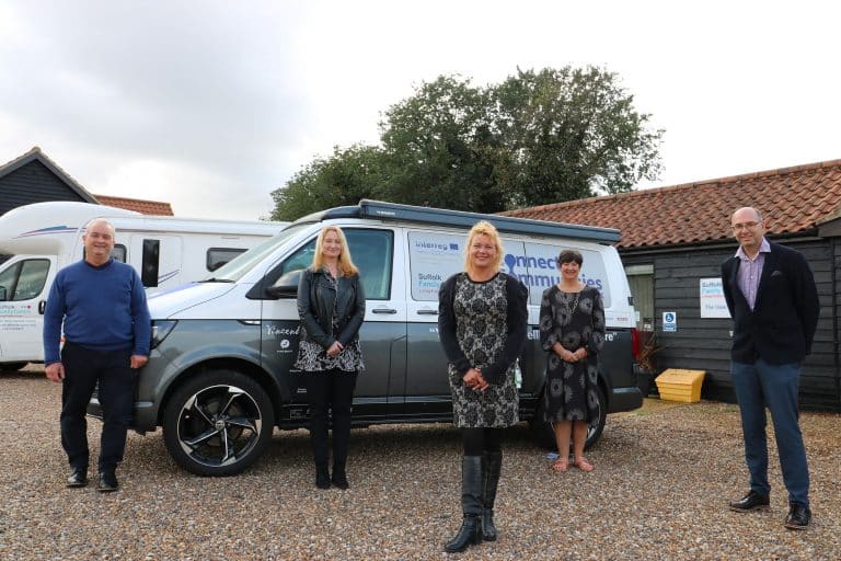 Suffolk Business team standing beside service van outdoors in Suffolk.