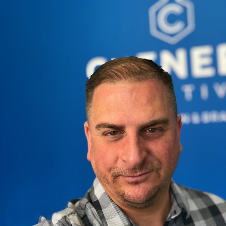 Professional portrait of a man at Suffolk Business event, smiling confidently.
