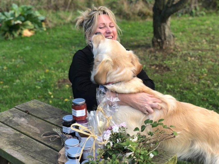 Golden retriever and woman enjoying a moment in the park.