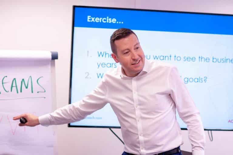 Business coach presenting during a workshop in Suffolk, engaging entrepreneurs and professionals.