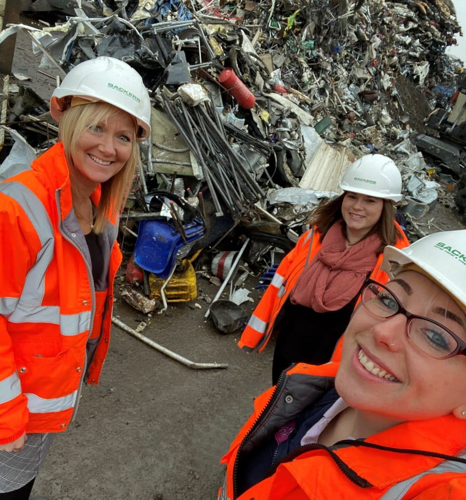 Suffolk waste management team inspecting recycling site with debris pile.