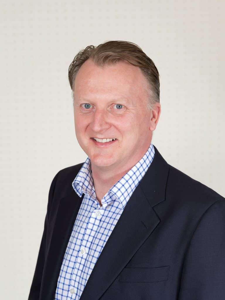 Suffolk Business professional in formal attire, smiling at the camera.