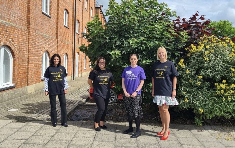 Group of four women standing outdoors in Suffolk, smiling for the camera.