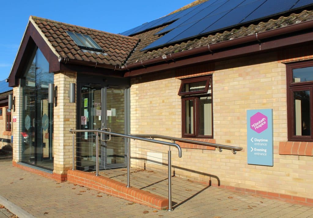 Modern Suffolk business office entrance with solar panels and accessible ramp.