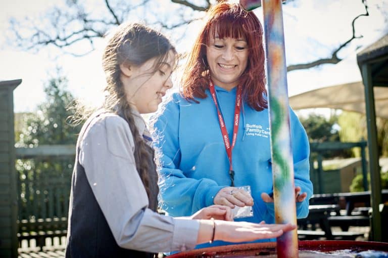 Suffolk community event with woman and girl enjoying outdoor activity in Suffolk.