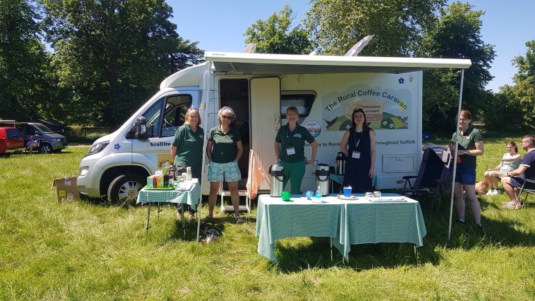 Mobile coffee van serving fresh brews at Suffolk outdoor event.