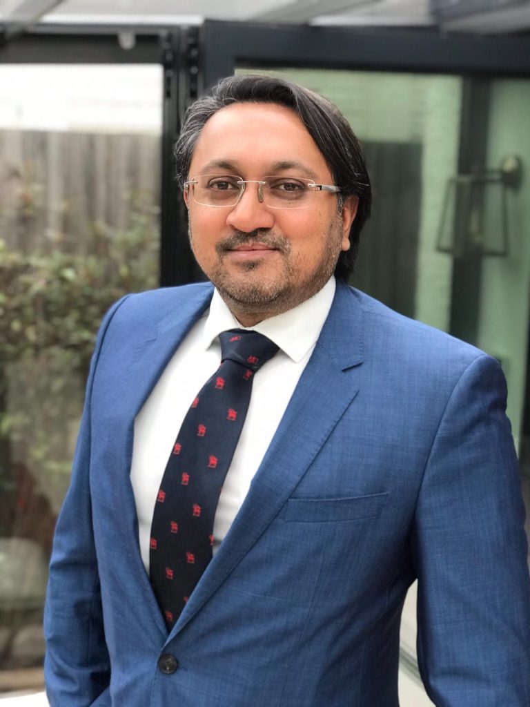 Professional businessman in Suffolk wearing a blue suit and tie.