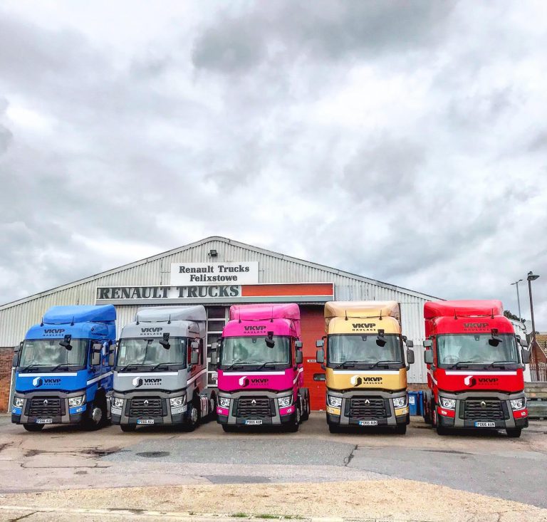 Colourful fleet of Renault trucks parked outside Suffolk business dealership.