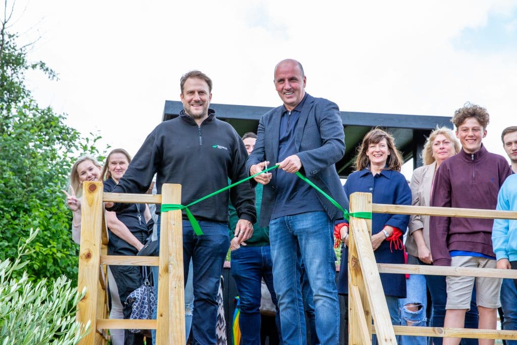Community leaders cut ribbon at new Suffolk playground opening event.