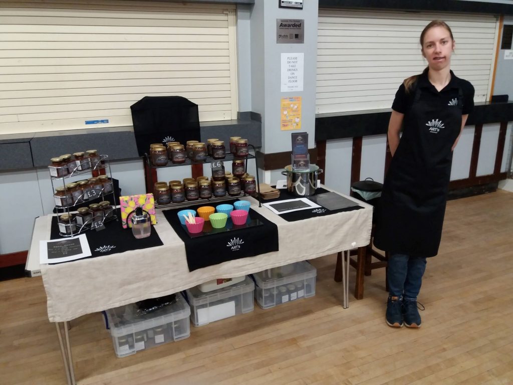 Local artisan jam and honey stall at Suffolk Business event in a community hall.