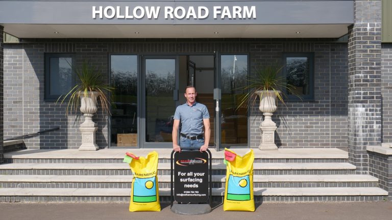 Hollow Road Farm entrance with surfacing equipment for road maintenance and construction.