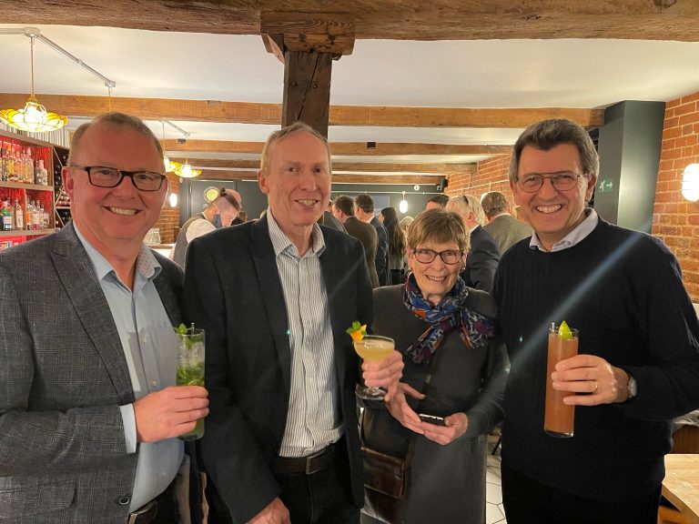 Business professionals enjoying networking drinks at Suffolk Business event.