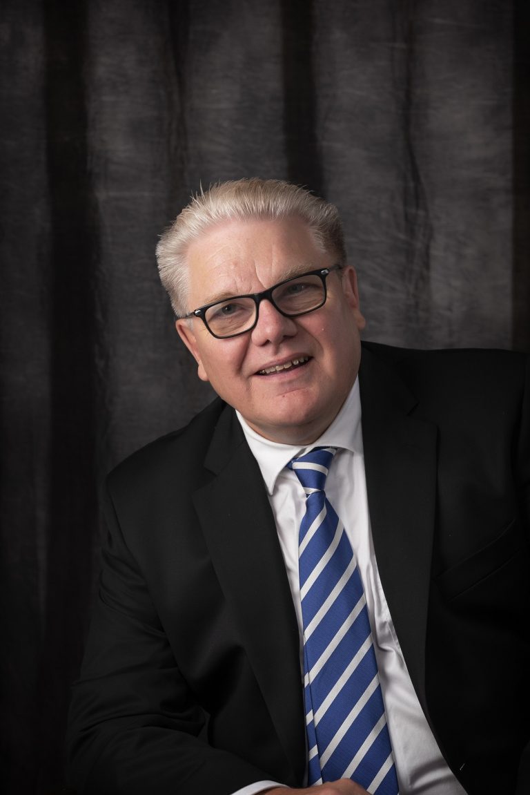 Business professional portrait of a man in a suit and tie, Suffolk business setting.