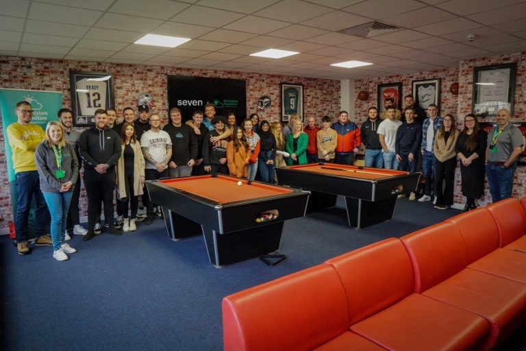 Group of professionals at a Suffolk business team-building event with pool tables.