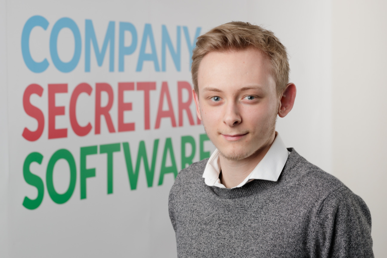 Young professional in office with company secretary software background.