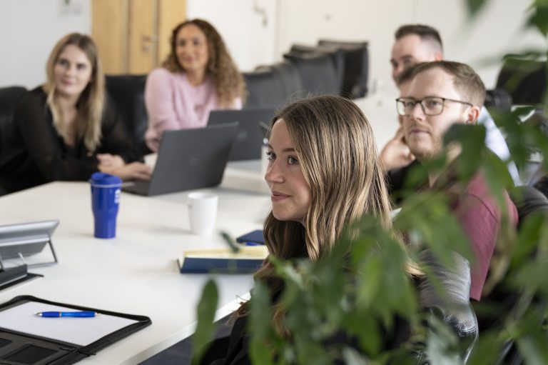 Business meeting with diverse team in modern office environment in Suffolk.
