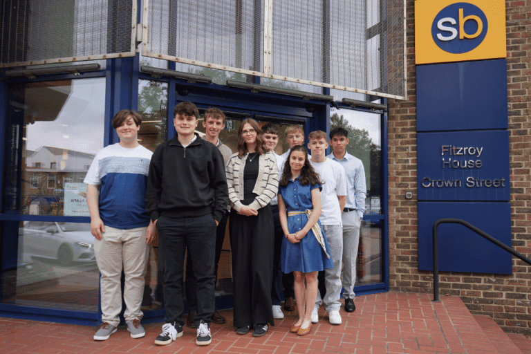 Young professionals standing outside Suffolk Business office in Ipswich, showcasing local business c.